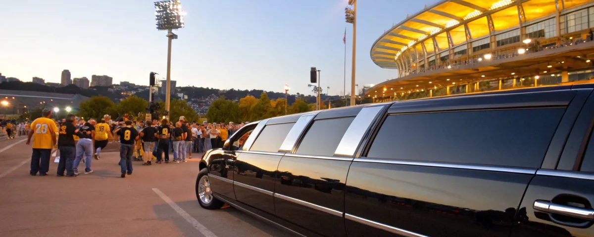 Fans arriving at a stadium in a limo for a sporting event.