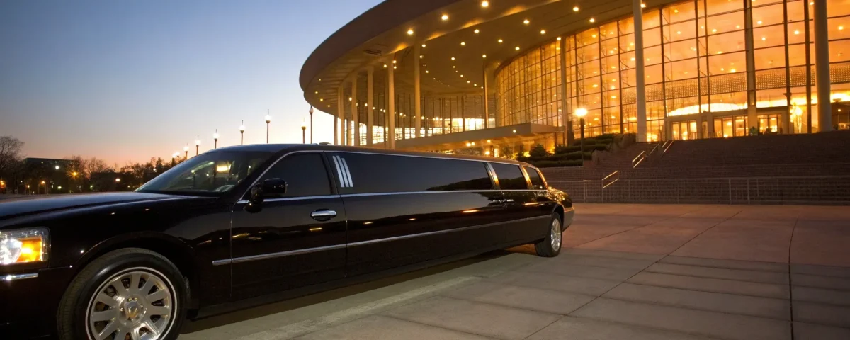 A black stretch limo parked at the Ball Arena center for a special event.