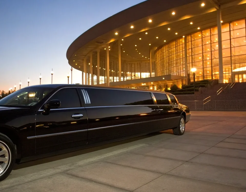 A black stretch limo parked at the Ball Arena center for a special event.