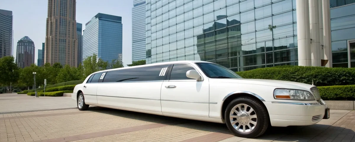 A white stretch limo for a luxury service, a common setting for driver gratuity.