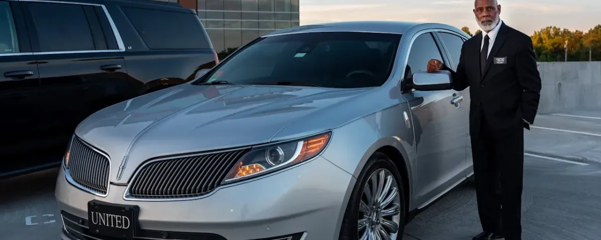 Corporate limo service in Denver with a black Cadillac Escalade ESV parked outside a downtown office building