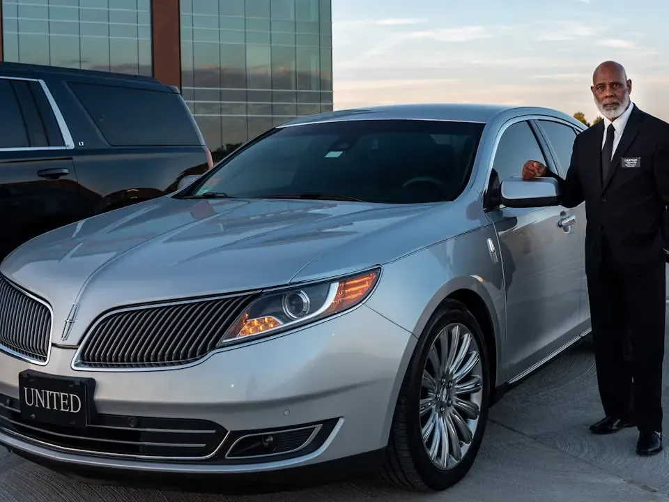 Corporate limo service in Denver with a black Cadillac Escalade ESV parked outside a downtown office building